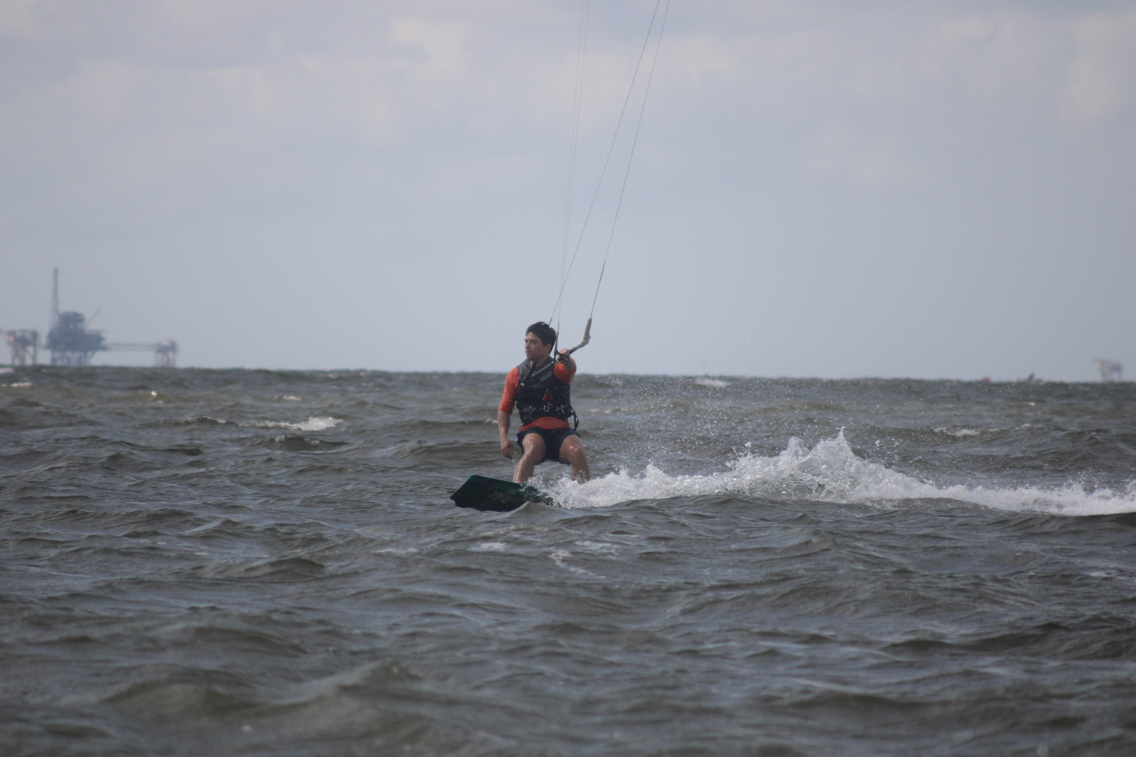 Micah kiteboarding on turquoise water