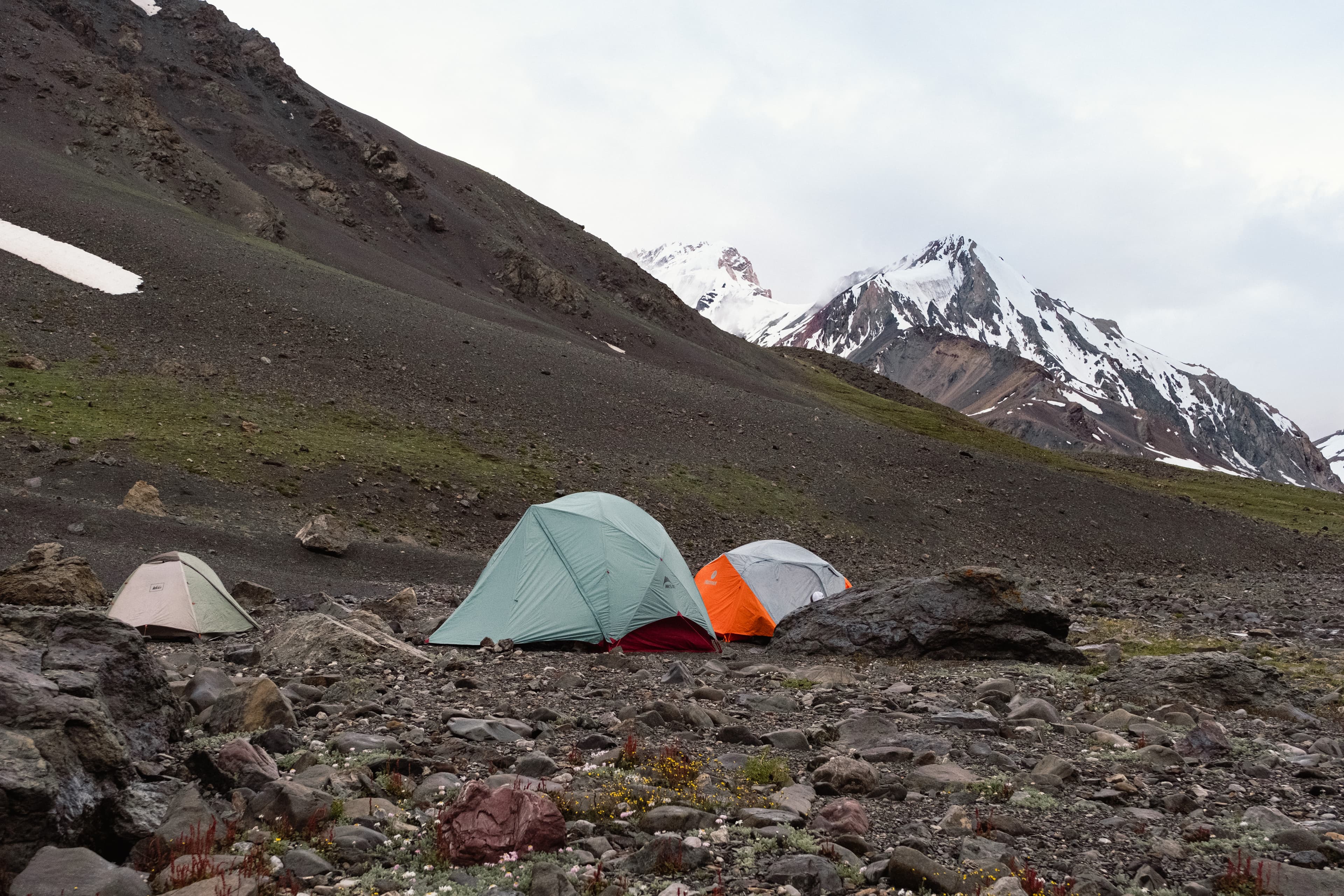 A campsite with glowing tents at dusk